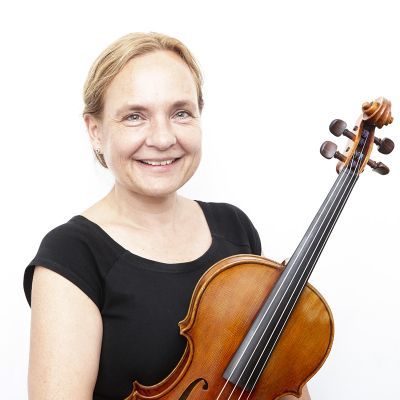 Sarah Harris holds a violin